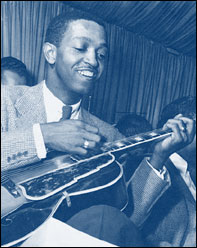 Photo of guitarist Freddie Green playing a Stomberg guitar.